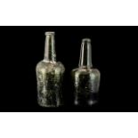 Two 18th Century Green Glass Wine Bottles with moulded tops and long necks.