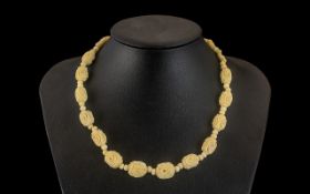 Antique Ivory Carved Necklace. Ivory necklace carved in good detail, 16" in length.