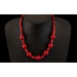 A Modern Cherry Amber and Coral Coloured Necklace. 18 Inches In length.