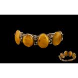Butterscotch Amber/Bakelite Bracelet. Amber bracelet in white metal. Largest stone being 11".