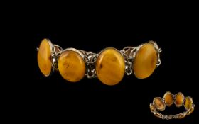 Butterscotch Amber/Bakelite Bracelet. Amber bracelet in white metal. Largest stone being 11".