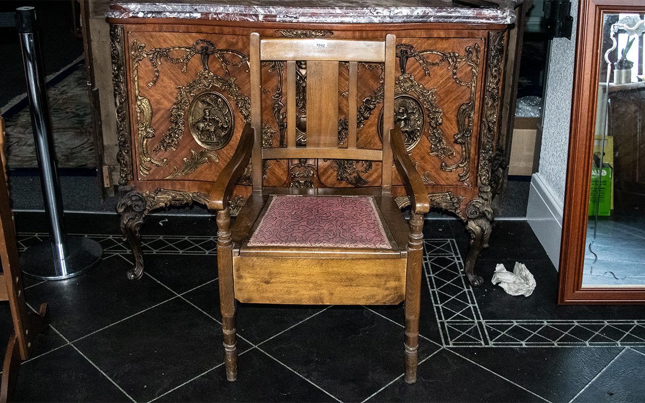 A Mahogany Commode with fitted pan and cushioned hinged seat.