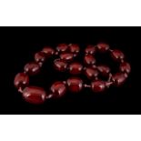 An Amber Coloured Cherry Bead Necklace - Individually knotted, Length 30 Inches.