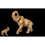 Large Resin Elephant Figure depicting an elephant with his trunk up, in ivory colour.