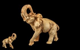 Large Resin Elephant Figure depicting an elephant with his trunk up, in ivory colour.