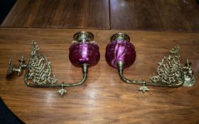 A Pair of Victorian Ruby Red Wall Bracket Oil Lamps with Ruby Font and brass filigree and Funnel,