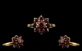 9ct Gold Garnet Set Ring, with a flower head design. Ring Size L.
