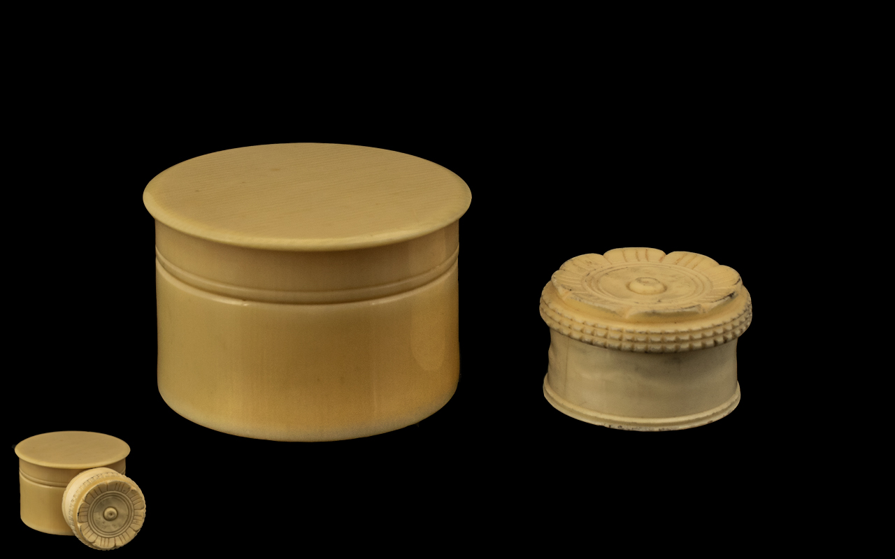 Two Ivory Lidded Pots, both of cylinder