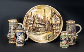 Four German Stein ware Tankards various heights together with a large German wall hanging plaque