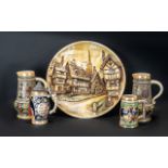 Four German Stein ware Tankards various heights together with a large German wall hanging plaque