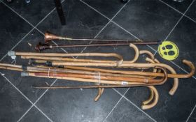 A Collection of Walking Sticks including one with the handle modelled as Sherlock Holmes.