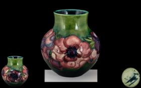 Moorcroft - Small Tube lined Vase of Bulbous Form ' Clematis ' Pattern on Emerald Green Ground. c.