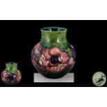 Moorcroft - Small Tube lined Vase of Bulbous Form ' Clematis ' Pattern on Emerald Green Ground. c.