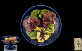 William Moorcroft Signed Tube lined Tazza with Hibiscus Pattern to Centre of Bowl on a Royal Blue