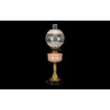 Victorian Oil Lamp with Pink Glass Font, Supported on a Brass Reeded Column on a Black Pottery Base,