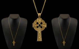 A 9ct Gold Stylished Celtic Cross with Sapphire Inset Attached to a Long 9ct Gold Chain.