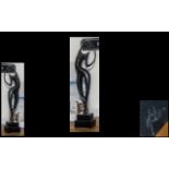 An Abstract Bronze Figure raised on a marble base. Signed Milo. Measures three feet in height.