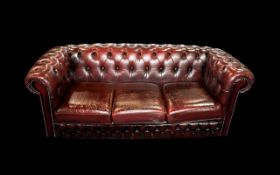 An Ox Blood Leather Chesterfield Sofa. With button back and arms.