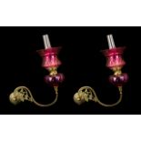 A Pair of Victorian Brass Gaselier Arm Wall Fitments converted to Oil Lamps with a ruby glass font