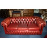 An Ox Blood Leather Chesterfield Sofa. With button back and arms.