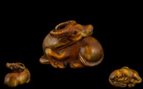 Modern Netsuke In Boxwood In Form of a Sitting Water Buffalo.