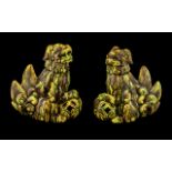 Pair of Antique Chinese Foo Temple Dogs, with an unusual yellow and green splash glaze. Both dogs