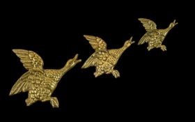 A Set of Three Antique Heavy Brass Wall Hanging Bird Figures. Measuring 11, 9 and 7 inches.