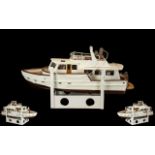 Model Boat of a cruiser ship on plinth. Comes with associated remote control. Measures 26 inches.