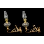 A Pair of Vintage Oil Lamps fitted to a candlestick wall bracket in brass.