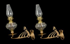 A Pair of Vintage Oil Lamps fitted to a candlestick wall bracket in brass.