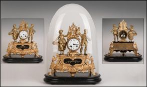 Antique French Gilt Metal Mantle Clock under a glass dome. The central clock flanked by a loving