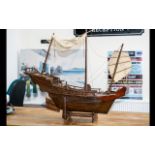 Model Boat of A Pirate Ship made out of wood and on a plinth. Chinese engravings to the rear.