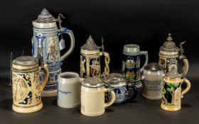 Collection of 10 German Stein Tankards, comprising: tall 15" tankard in glazed blue,