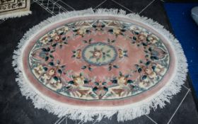 Traditional Oval Wool Rug in pink with floral designs and fringed edges, measures approx.