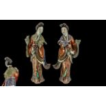 Pair of Chinese Antique Famile Rose Figures of Maidens Holding Lotus Blossoms,