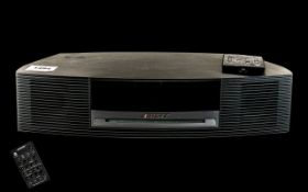 A Bose Wave Music System Model AWRCC5 with remote control.