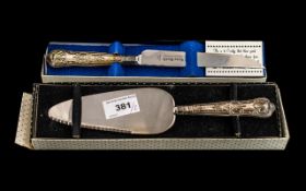 2 Boxed Silver Hilted Bread Knife and Cake Scoops. Please See Photo.