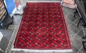 A Genuine Excellent Quality Persian Turkmen Carpet/Rug decorated in a Bukhari design on red