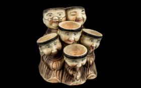 Vintage Pottery Monk Egg Holder, holds six eggs, depicts six Monks with individually painted faces.