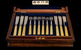 Cutlery Set Housed in a Handsome Polished wooden box with brass cartouche to centre,