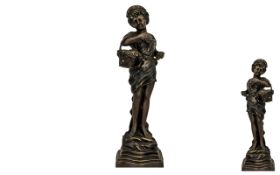 Reproduction Bronze of a Girl Carrying a Basket of Fruit, measures 24" high.