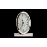 A Contemporary Sterling Silver Oval Shaped Small Table / Desk Clock with Quartz Movement.