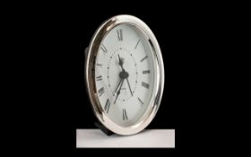 A Contemporary Sterling Silver Oval Shaped Small Table / Desk Clock with Quartz Movement.