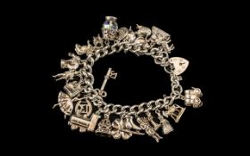 Early to Mid 20th Century Silver Bracelet Loaded with 23 Silver Charms.