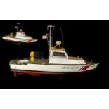 Model Lifeboat coast guard ship on plinth. Comes with associated remote control. Measures 33