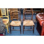 A Pair of Antique Rush Seated Elm Spindle Back Country Chairs. On tapering round legs, circa 1800s.