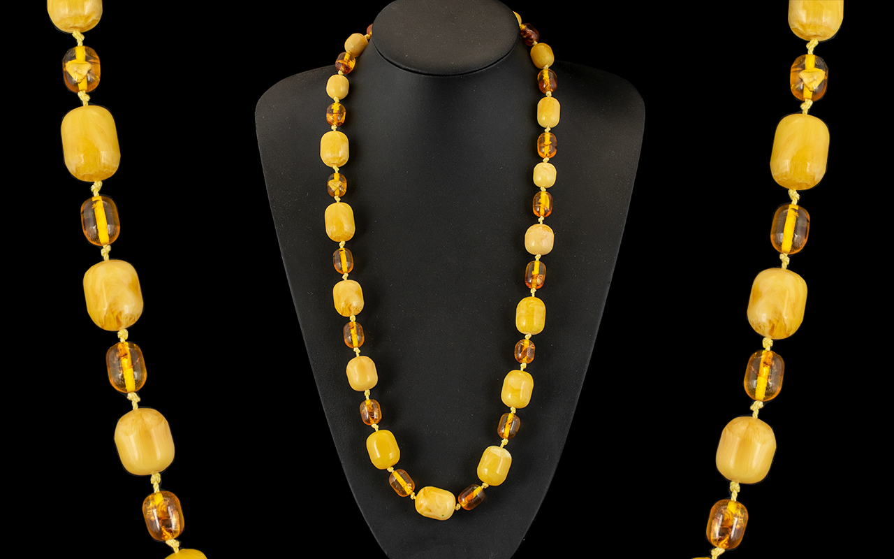 Amber Coloured Beads. Colour of Egg Yolk, Barrel Shaped. Double Knotted, 26 Inches In length. 78