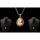 A 9ct Gold Mounted Shell Cameo Pendant - Attached to a 9ct Gold Quality Long Chain. Both Marked