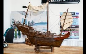 Model Boat of A Pirate Ship made out of wood and on a plinth. Chinese engravings to the rear.