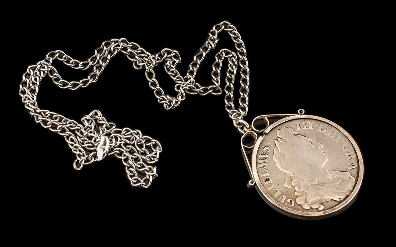 A 1695 William III Silver Crown worn condition in mount with chain.